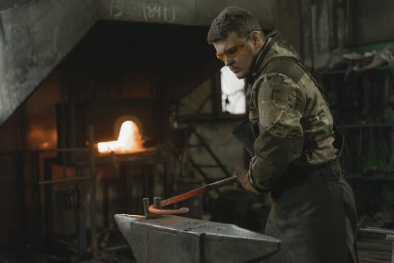 Man Using and Anvil to bend Metal
